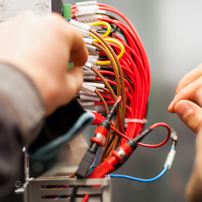 electrician hands close up wiring electrical panel at building ashland ma